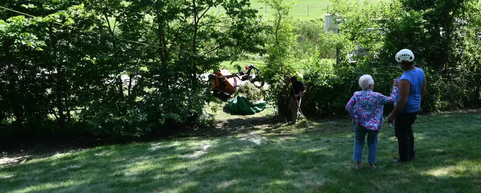 Homeowner standing in a clean back yard after an Urban Tree removal in Minneapolis MN